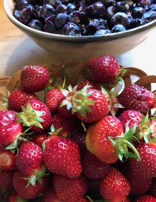 Last frozen blueberries, fresh picked strawberries